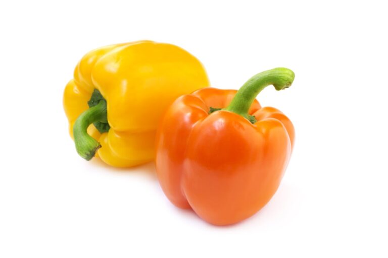 close up of two bell peppers on white background